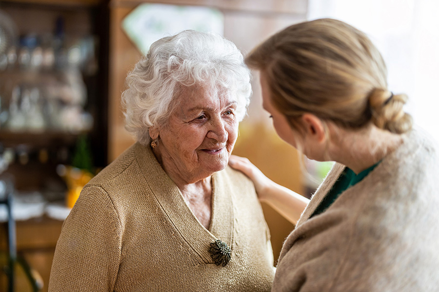 senior care specialist with older woman at house interiors arundel me